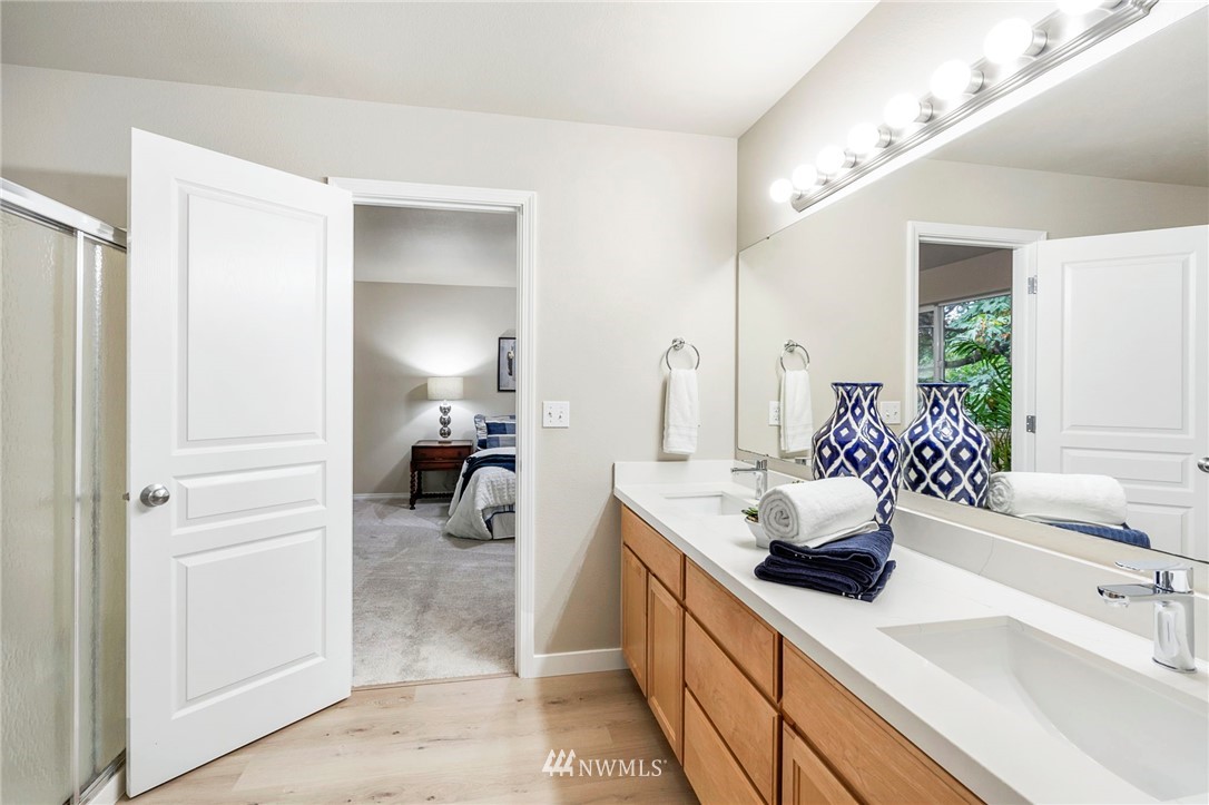 6719 Southeast 5th Street Renton, WA 98059 - Photo 17 of 29 a en suite bathroom with a double vanity sink and a large mirror