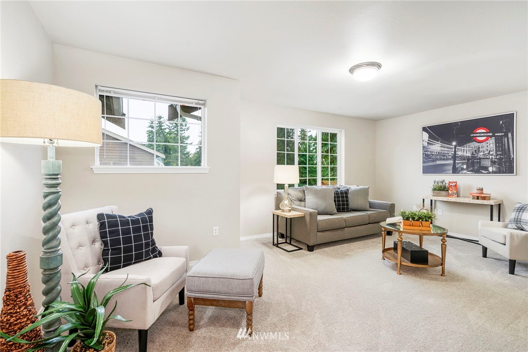 6719 Southeast 5th Street Renton, WA 98059 - Photo 23 of 29 a living room with furniture and a large window
