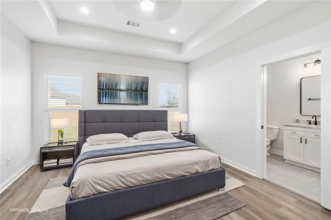 2102 Joppi Court Bryan, TX 77807 - Photo 27 of 27 a bedroom with a bed and a chandelier