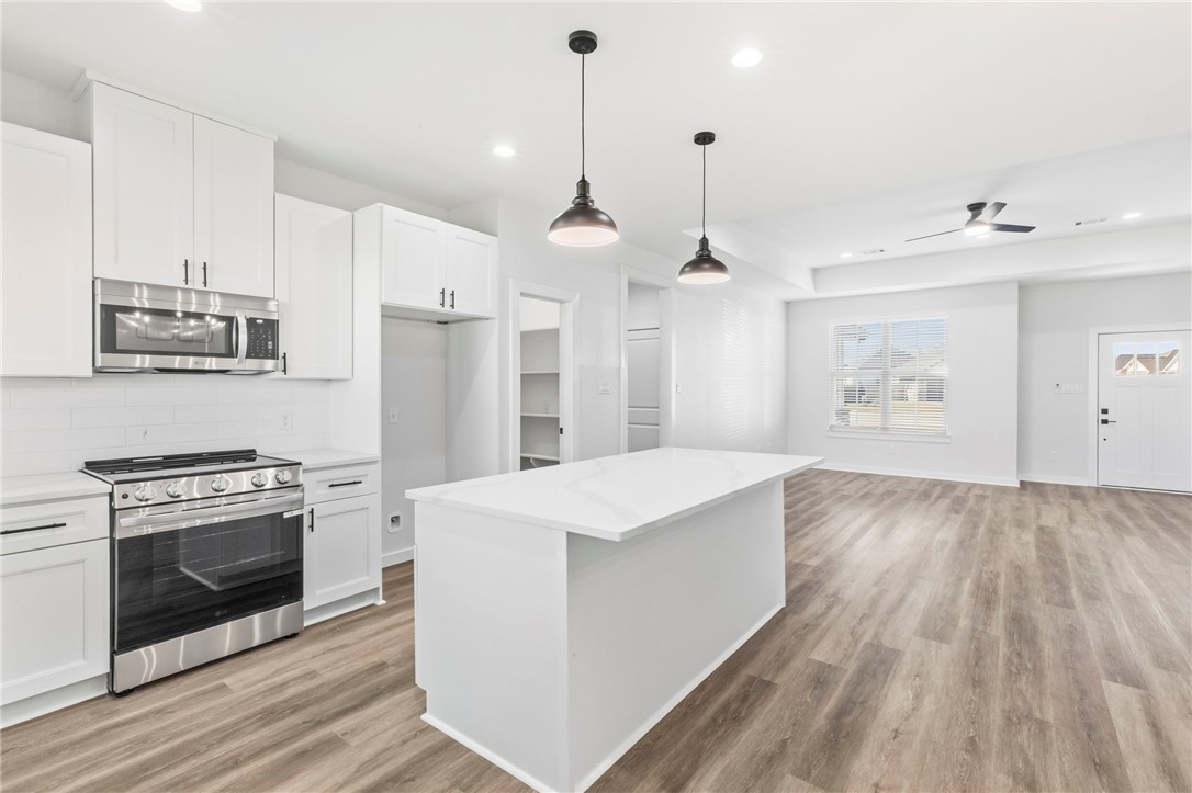 2102 Joppi Court Bryan, TX 77807 - Photo 6 of 27 a kitchen with stainless steel appliances granite countertop a stove oven and a refrigerator