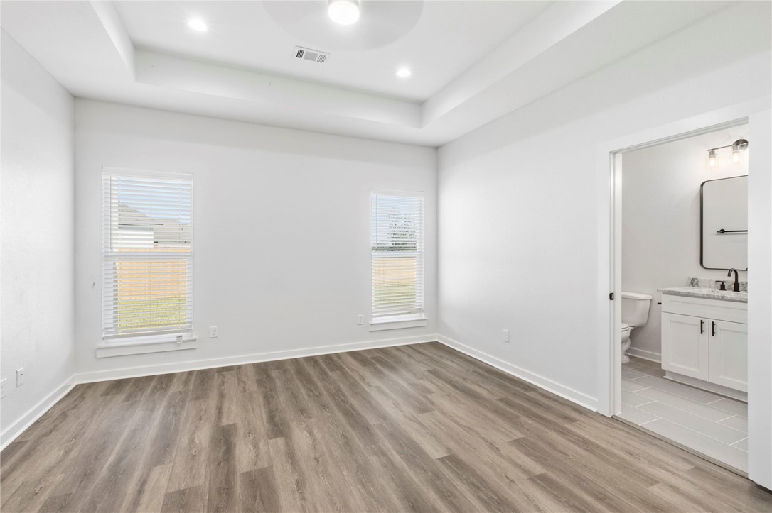 2102 Joppi Court Bryan, TX 77807 - Photo 9 of 27 wooden floor in an empty room with a window