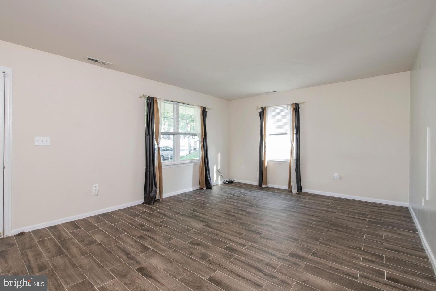 3718 Merrick Road Philadelphia, PA 19129 - Photo 28 of 30 a view of an empty room with wooden floor and a window