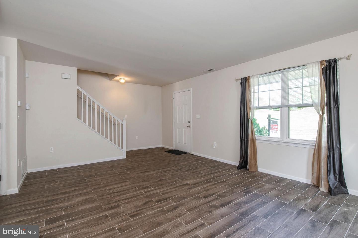 3718 Merrick Road Philadelphia, PA 19129 - Photo 29 of 30 a view of an empty room with wooden floor and a window