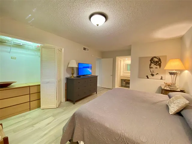 a bedroom with a bed and a night stand