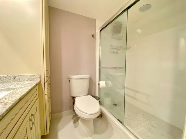 a bathroom with a toilet and a shower