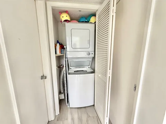a room with a refrigerator and a window