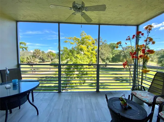 a view of a dining room with furniture a chandelier and wooden floor