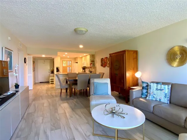 a living room with furniture a dining table and a fireplace
