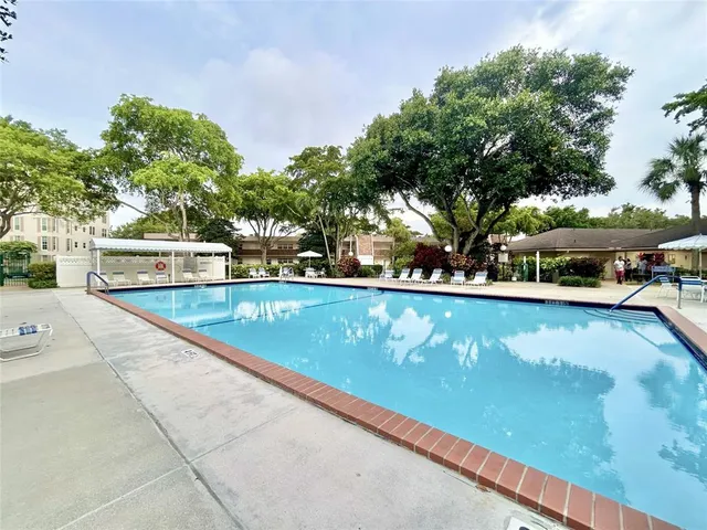 a view of a swimming pool with a yard