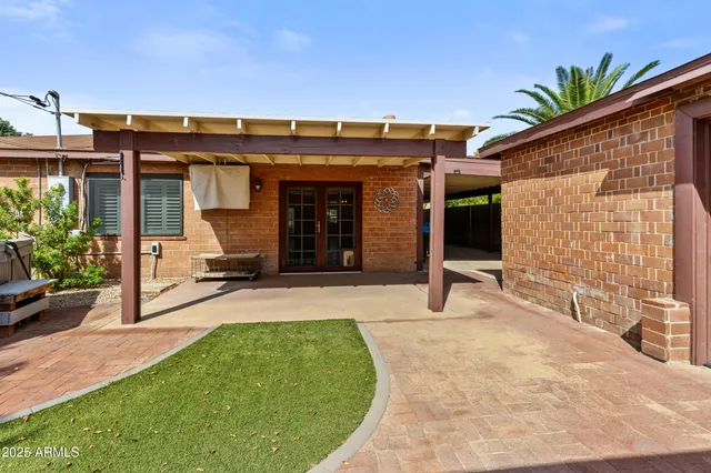 a kitchen with stainless steel appliances granite countertop a refrigerator a stove and a sink with wooden floor