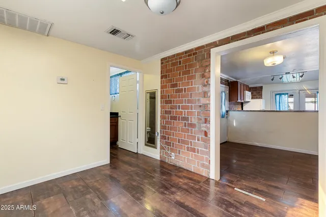 an empty room with wooden floor and closet