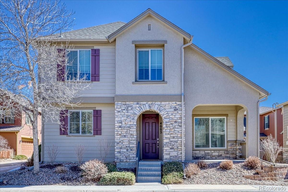 4005 Blue Pine Circle Highlands Ranch, CO 80126 - Photo 1 of 27 a front view of a house with garden