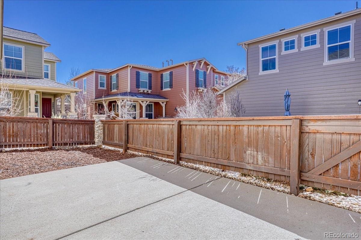 4005 Blue Pine Circle Highlands Ranch, CO 80126 - Photo 12 of 27 a view of a house with a wooden fence