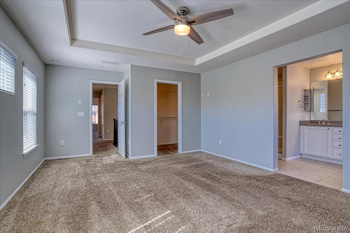 4005 Blue Pine Circle Highlands Ranch, CO 80126 - Photo 17 of 27 an empty room with closet and a chandelier fan