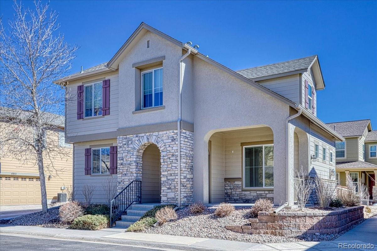4005 Blue Pine Circle Highlands Ranch, CO 80126 - Photo 2 of 27 a front view of a house with garden
