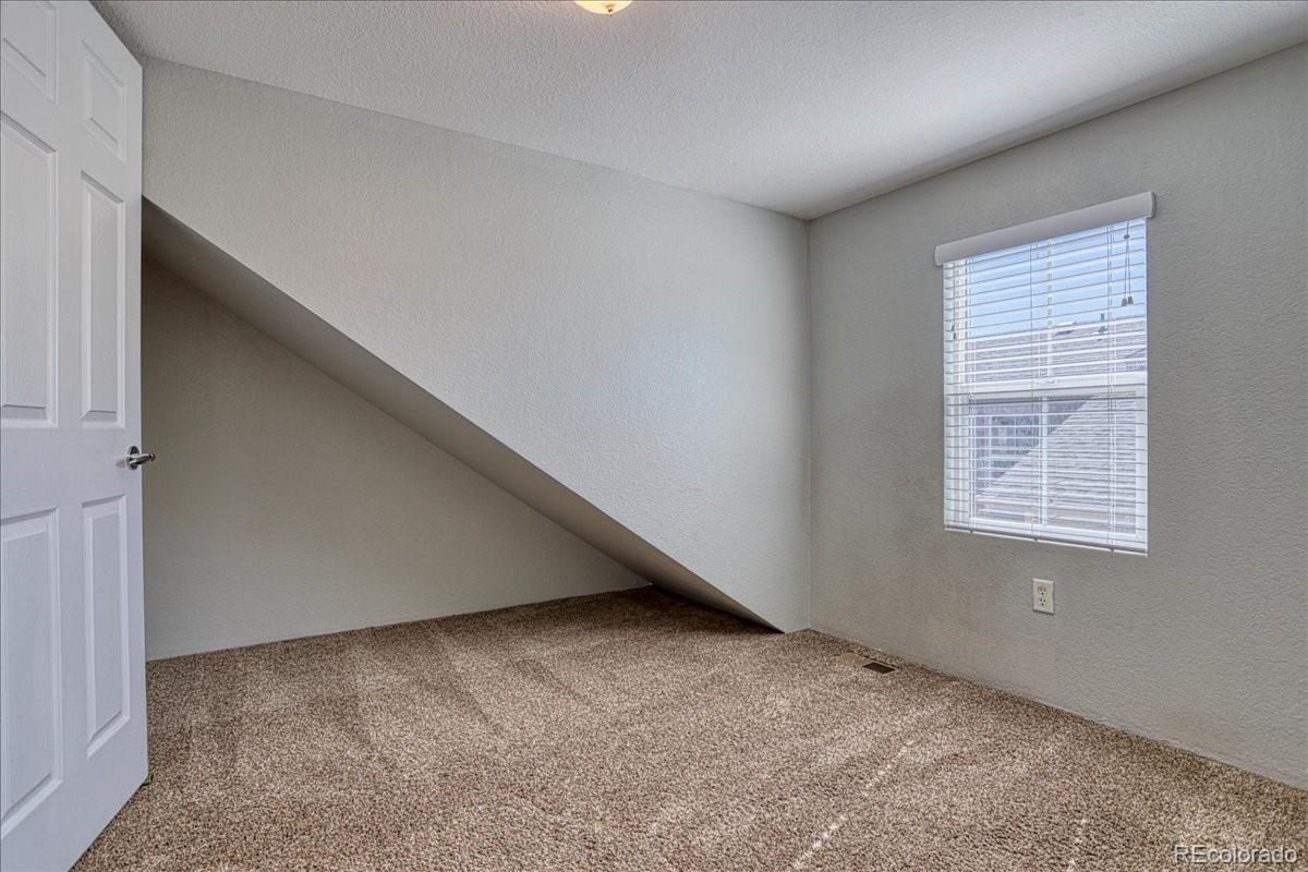 4005 Blue Pine Circle Highlands Ranch, CO 80126 - Photo 22 of 27 a view of an empty room with a window