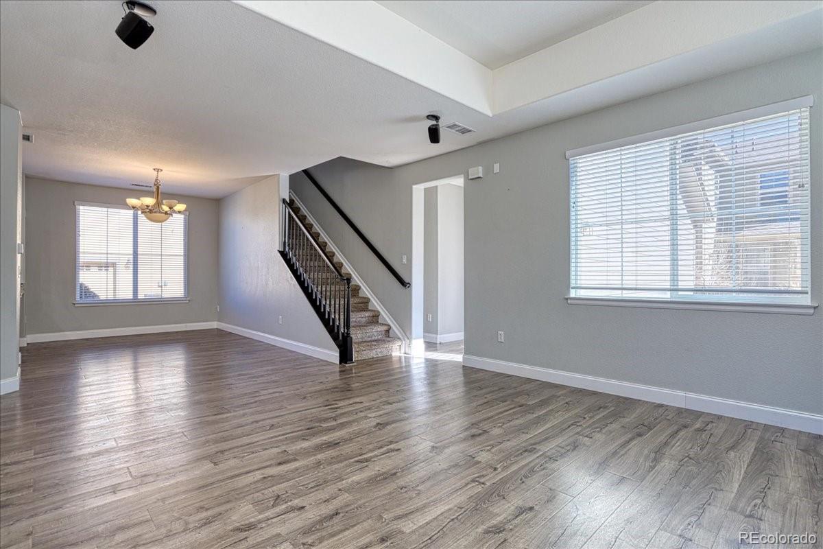 4005 Blue Pine Circle Highlands Ranch, CO 80126 - Photo 5 of 27 an empty room with wooden floor and windows