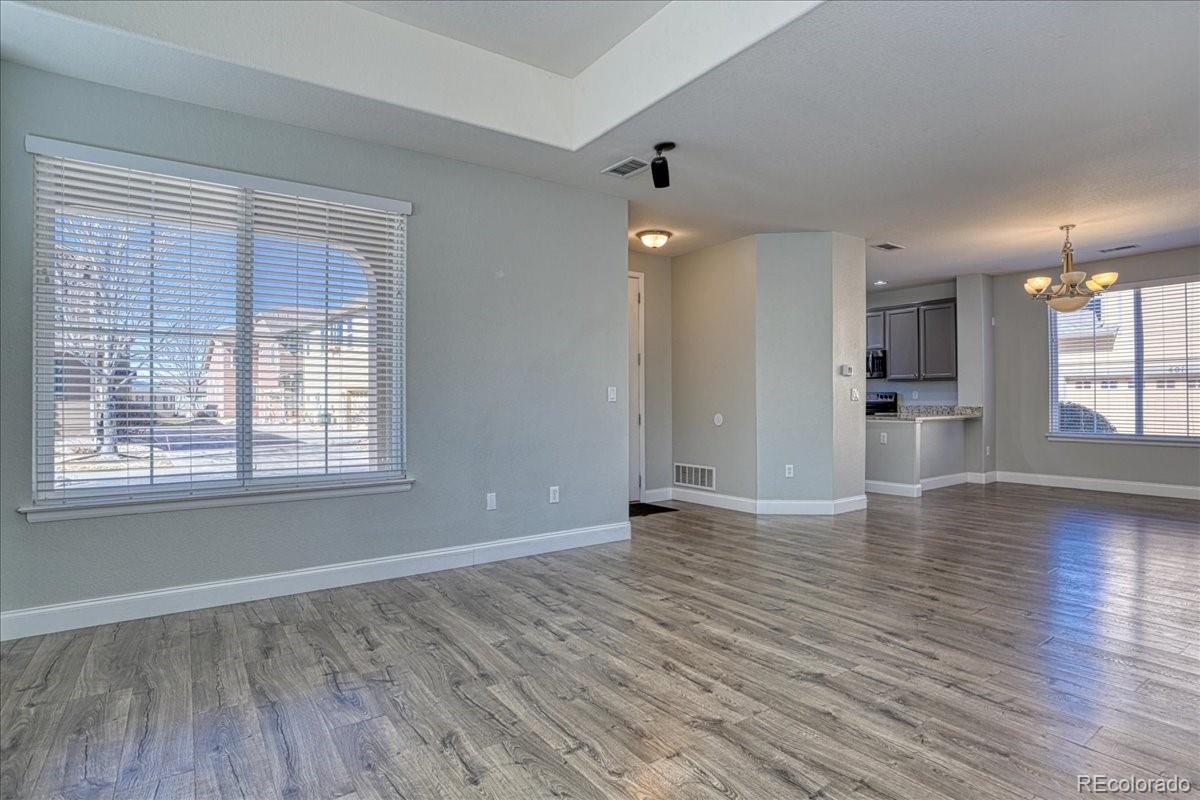 4005 Blue Pine Circle Highlands Ranch, CO 80126 - Photo 6 of 27 wooden floor in an empty room with a window