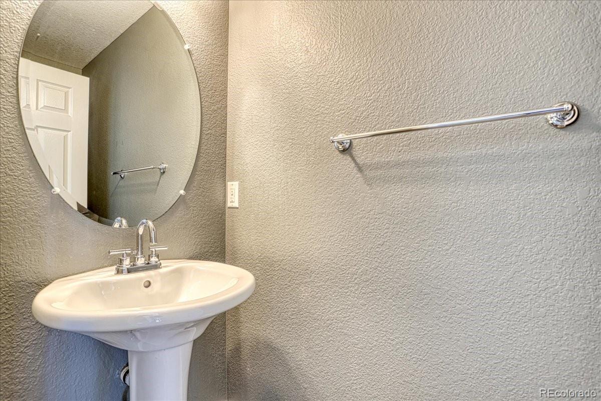 4005 Blue Pine Circle Highlands Ranch, CO 80126 - Photo 10 of 27 a bathroom with a sink a mirror and a shower