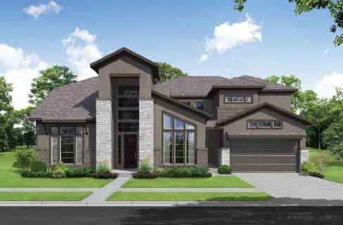 a view of a brick house with a yard plants and large tree