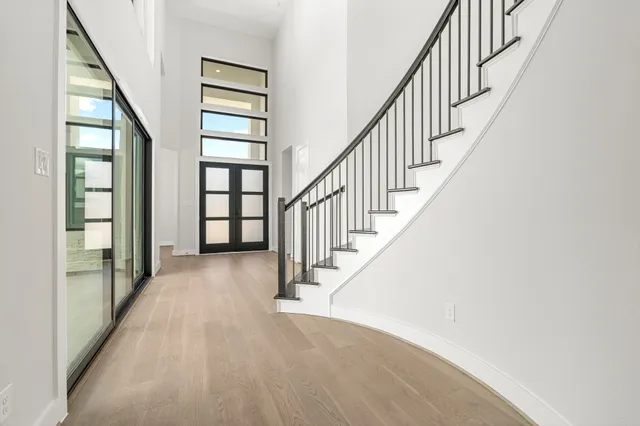 a view of an entryway with wooden floor