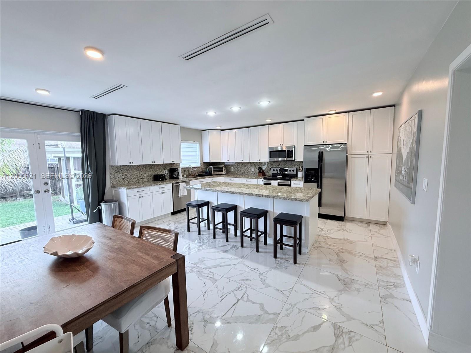 a kitchen with a table and chairs in it