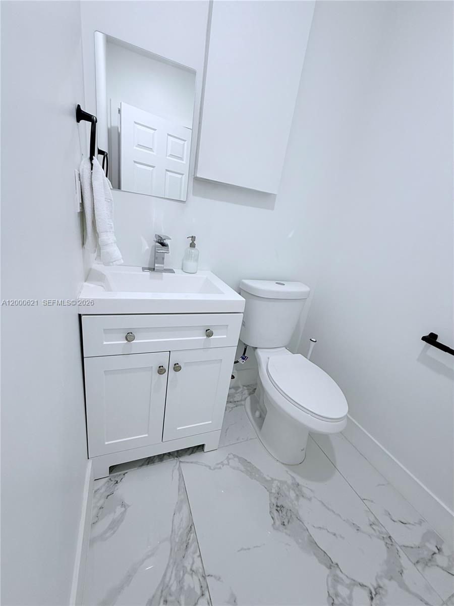 11020 Southwest 42nd Terrace Miami, FL 33165 - Photo 14 of 22 a bathroom with a sink a toilet and a mirror