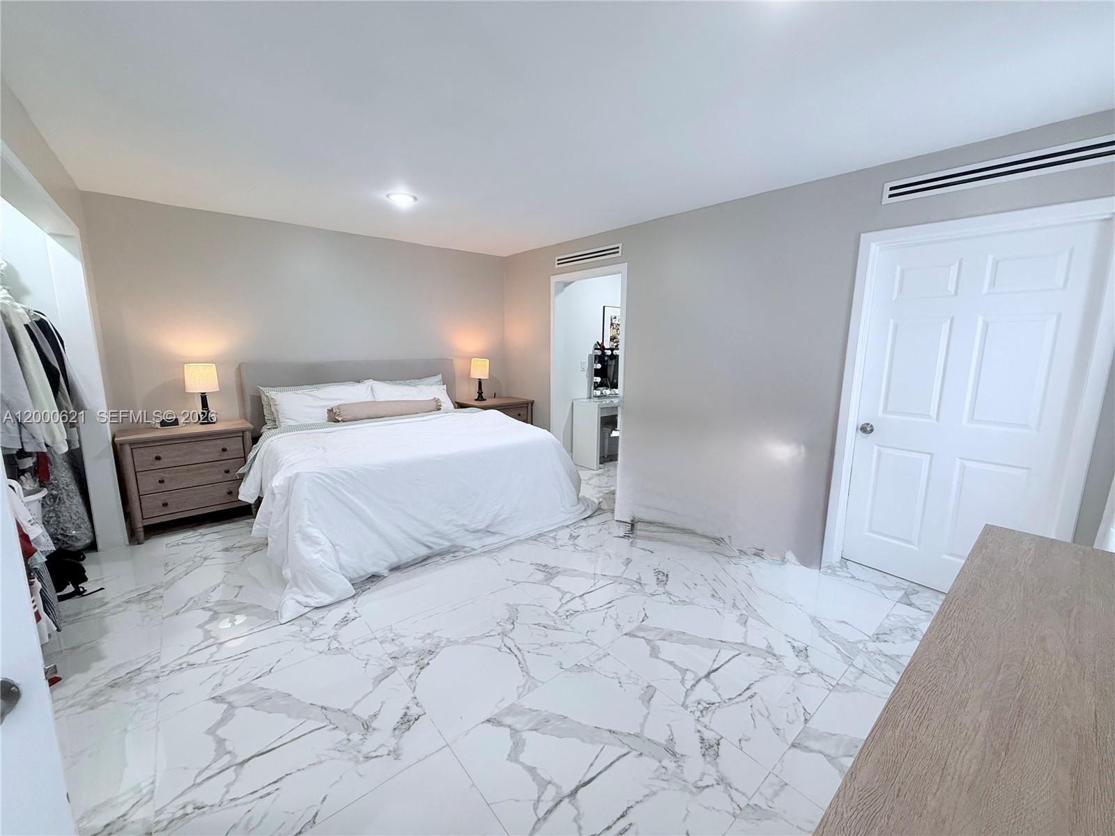 11020 Southwest 42nd Terrace Miami, FL 33165 - Photo 15 of 22 a bedroom with a bed and a refrigerator