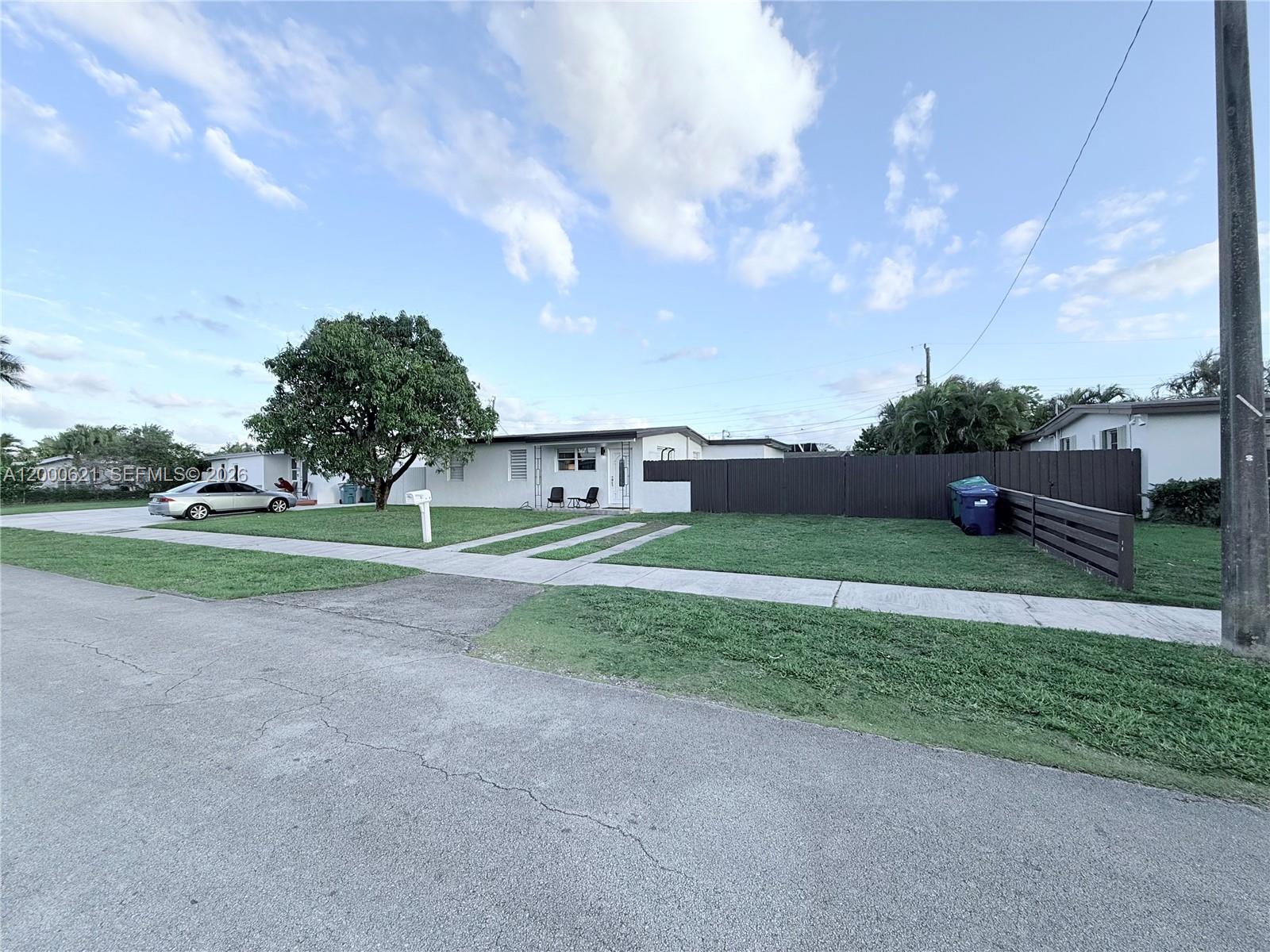 11020 Southwest 42nd Terrace Miami, FL 33165 - Photo 20 of 22 a view of a house with a big yard