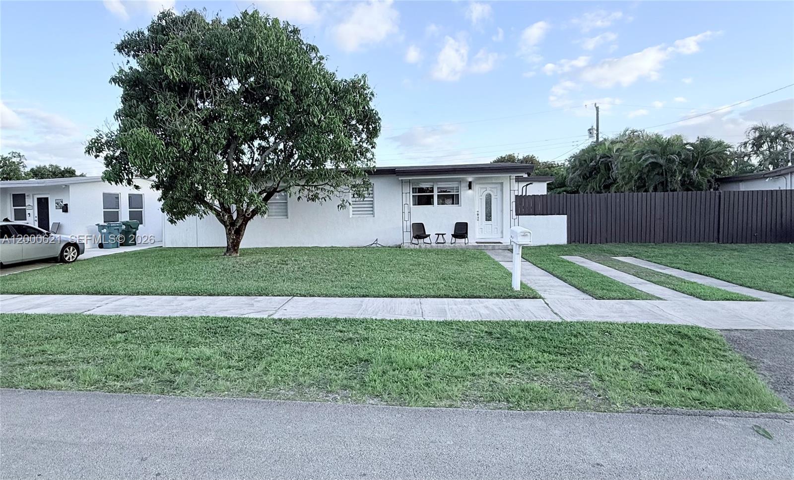 11020 Southwest 42nd Terrace Miami, FL 33165 - Photo 2 of 22 a view of a house with a yard and a large tree