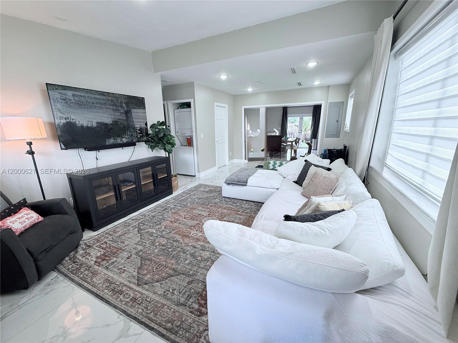 11020 Southwest 42nd Terrace Miami, FL 33165 - Photo 6 of 22 a living room with furniture and a flat screen tv