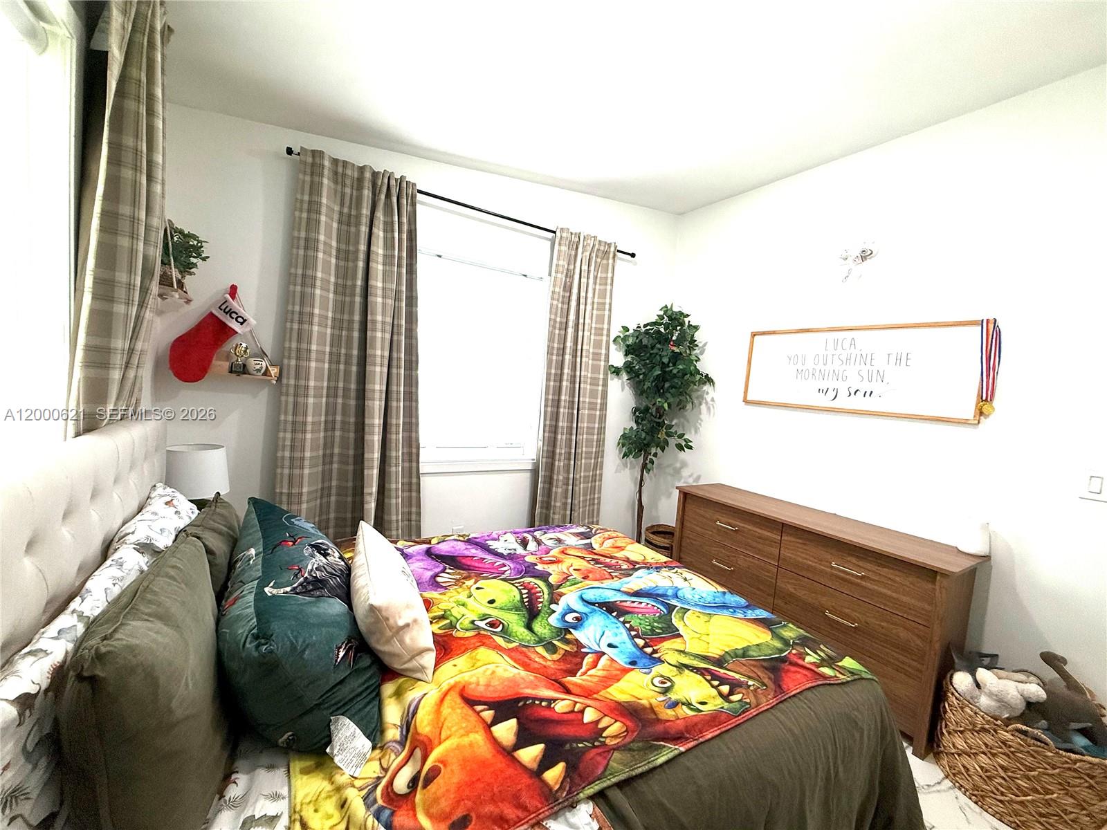11020 Southwest 42nd Terrace Miami, FL 33165 - Photo 10 of 22 a bed sitting in a bedroom next to a window