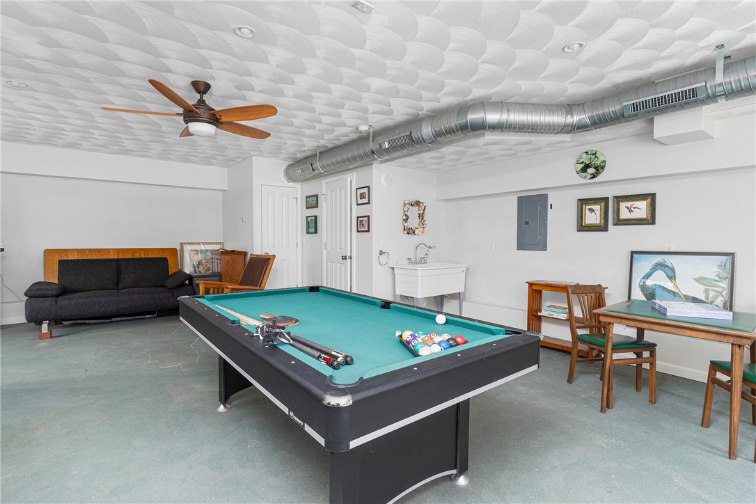 267 Widow Sweets Road Exeter, RI 02822 - Photo 36 of 46 First level recreation room in the accessory building...perfect spot for watching TV, games, ping pong or a pool table. It has 2 sets of glass sliders and a half bathroom.