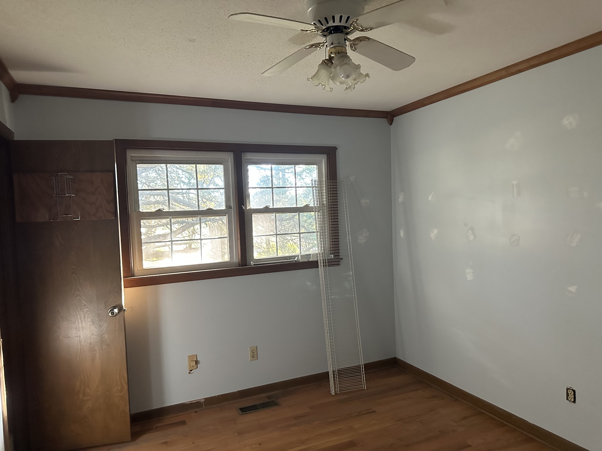 56 Gum Springs Road Lawrenceburg, TN 38464 - Photo 6 of 18 an empty room with wooden floor fan and windows