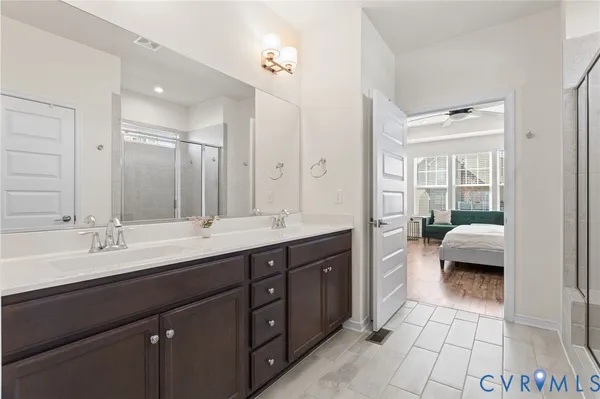 a en suite bathroom with a double sink and mirror
