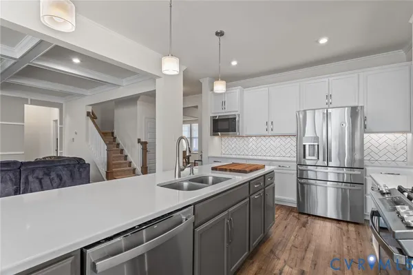 a kitchen with refrigerator cabinets and wooden floor