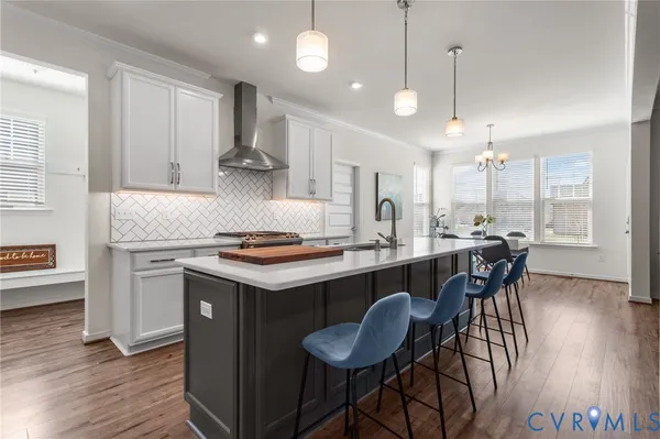 a kitchen with a stove and chairs