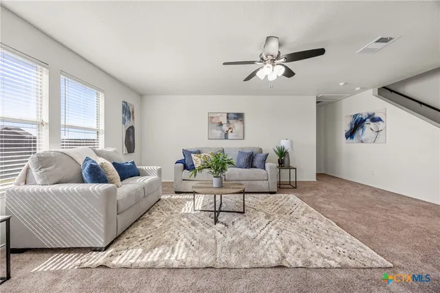 a living room with furniture and a rug