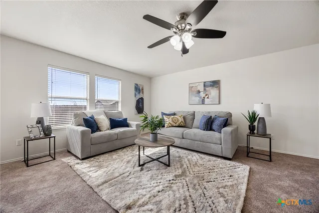 a living room with furniture and a large window