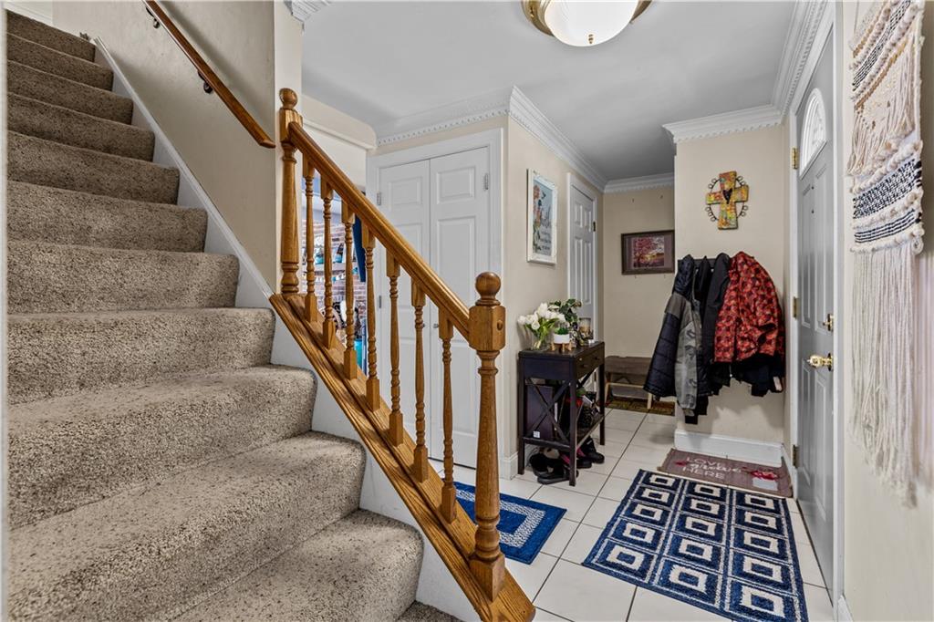2116 Ramsey Road Monroeville, PA 15146 - Photo 3 of 28 a view of a hallway with wooden floor and stairs