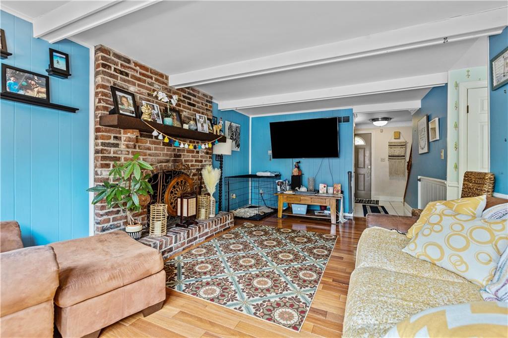 2116 Ramsey Road Monroeville, PA 15146 - Photo 7 of 28 a living room with furniture a flat screen tv and a table