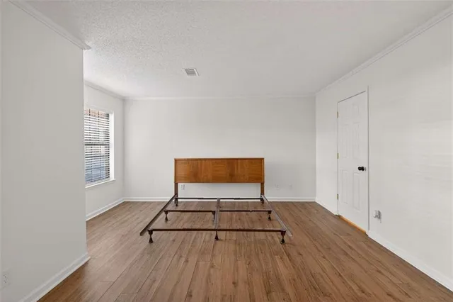 a view of a livingroom with wooden floor and a window