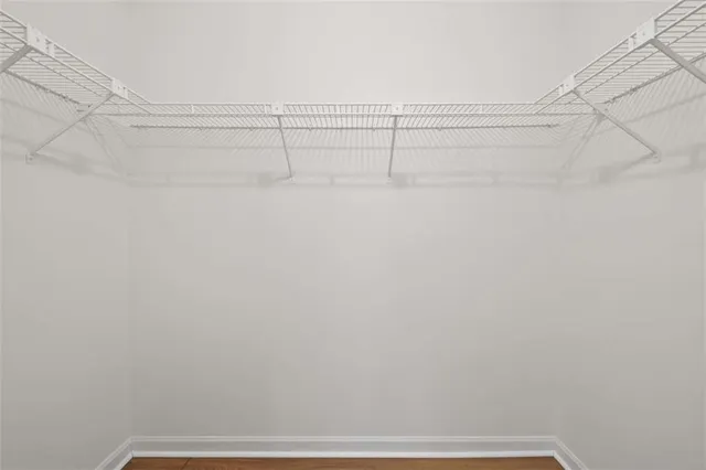 a view of a closet with racks on the wall