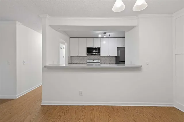 a view of a kitchen with a sink and a microwave