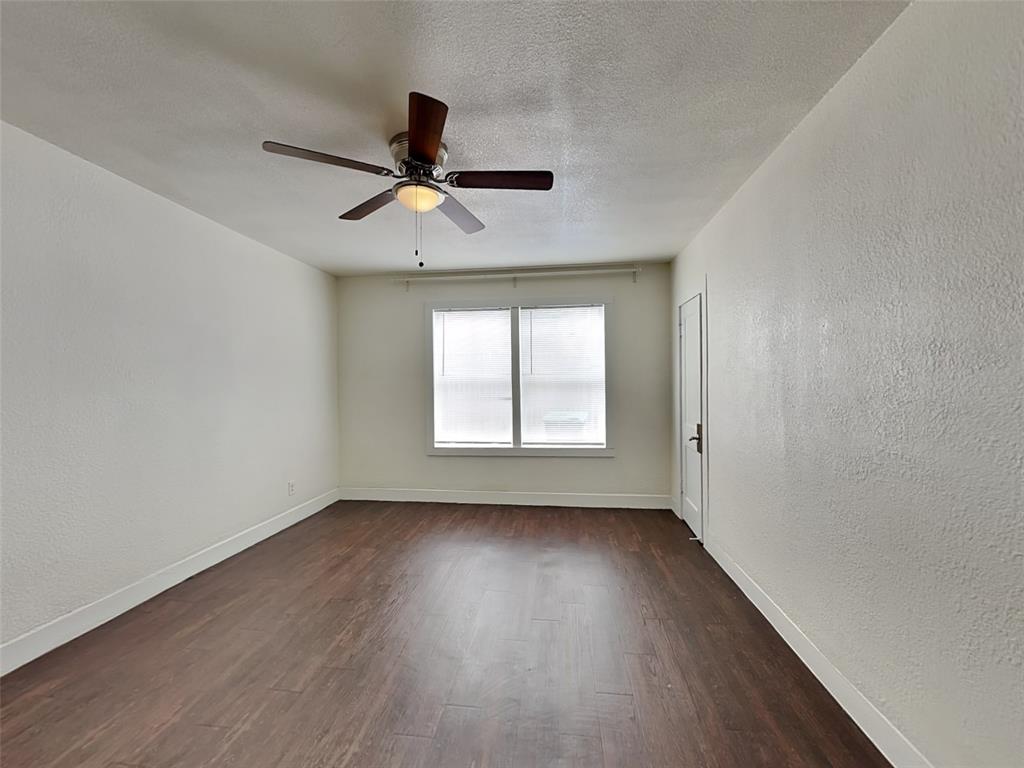 2911 Ryan Avenue Fort Worth, TX 76110 - Photo 11 of 27 an empty room with wooden floor fan and windows