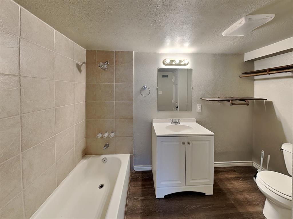 2911 Ryan Avenue Fort Worth, TX 76110 - Photo 22 of 27 a bathroom with a sink a toilet and shower