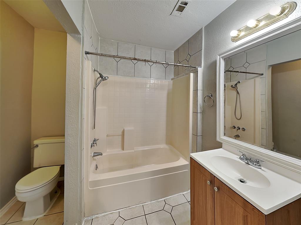 2911 Ryan Avenue Fort Worth, TX 76110 - Photo 27 of 27 a bathroom with a sink toilet and shower