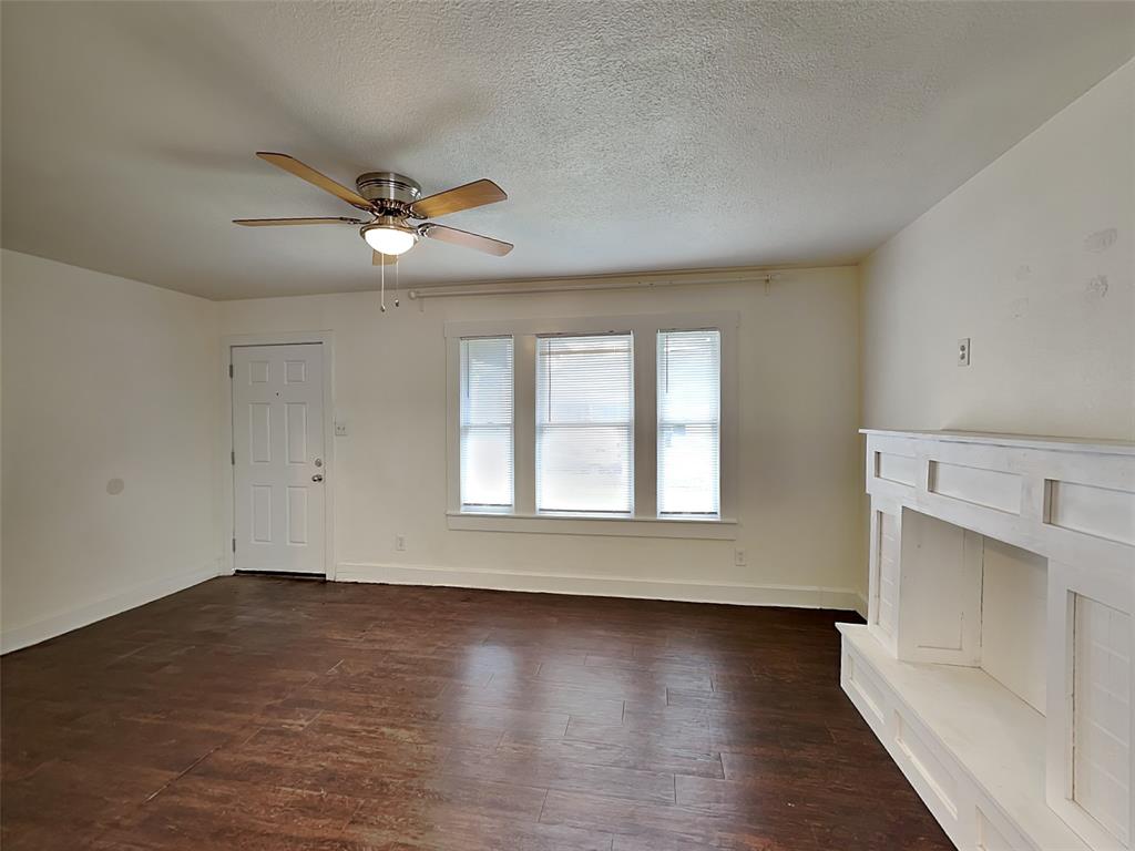 2911 Ryan Avenue Fort Worth, TX 76110 - Photo 3 of 27 wooden floor in an empty room with a window