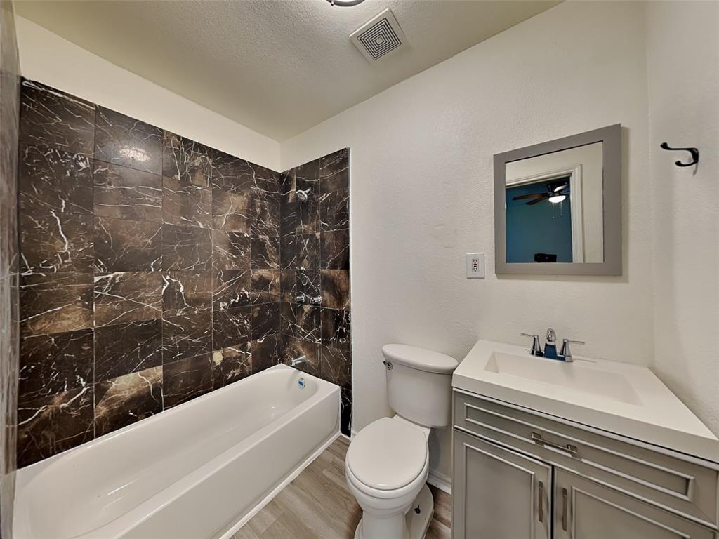 2911 Ryan Avenue Fort Worth, TX 76110 - Photo 8 of 27 a bathroom with a sink toilet and shower