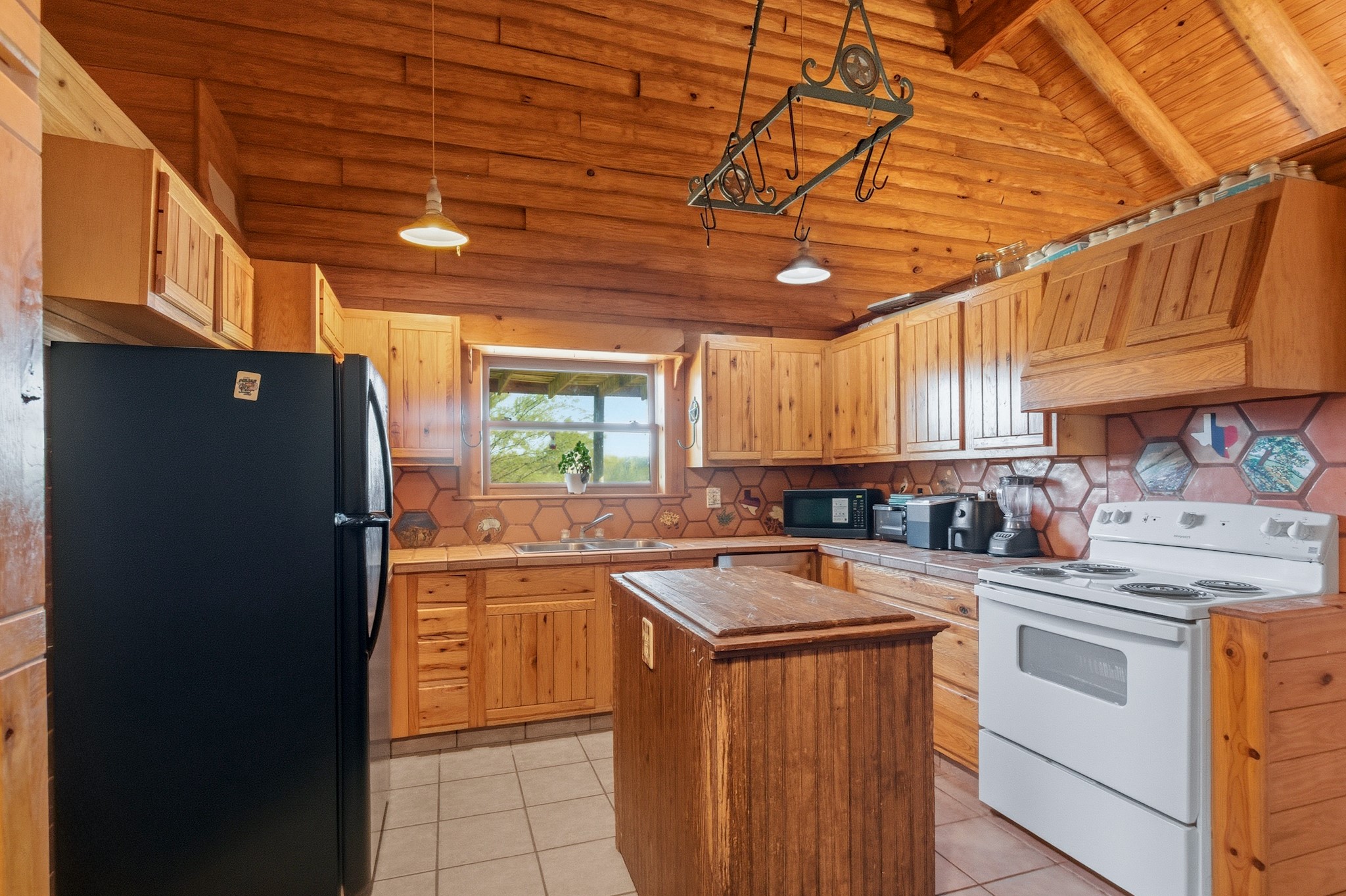 6347 Old Goliad Road Goliad, TX 77963 - Photo 18 of 42 a kitchen with stainless steel appliances granite countertop a sink stove and refrigerator